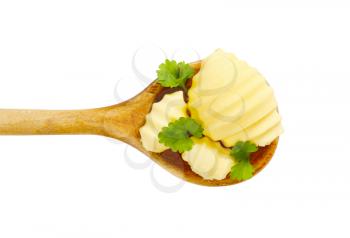 Butter curls on wooden spoon