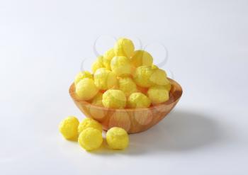 Puffed snack - Cereal balls in wooden bowl