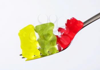 Three gummy bears on a fork