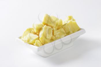 Pieces of white chocolate in a rectangular bowl