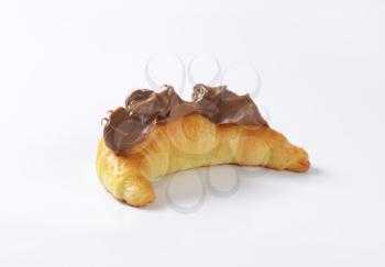croissant topped with chocolate butter spread