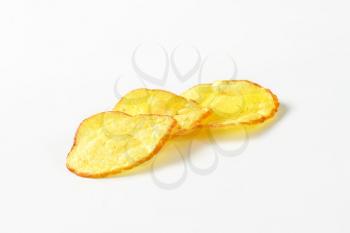 Three potato chips on white background
