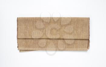 folded cotton yarn place mat on white background