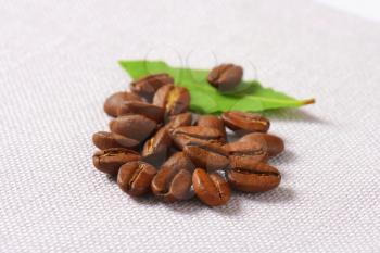 Roasted coffee beans on linen napkin