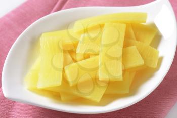 bowl of sliced bamboo shoots on pink tablecloth