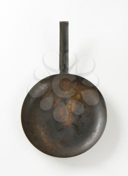 Rusty black skillet with one handle