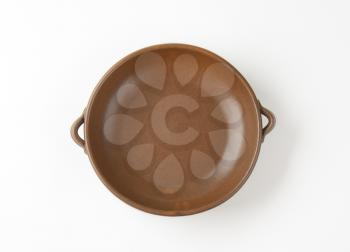 Empty round brown baking dish