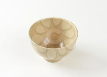 Empty beige bowl on white background