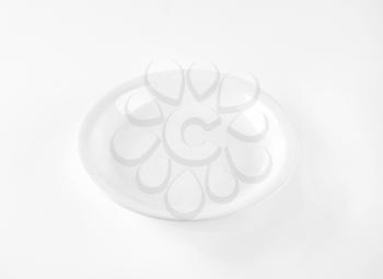 coupe shaped soup plate on white background