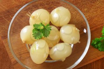 Small pickled onions on glass plate