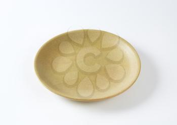 Beige coupe shaped dinner plate