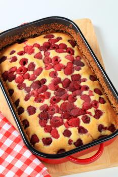 fresh baked raspberry sponge cake in baking tray