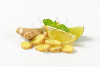fresh ginger with lemon and lime on white background