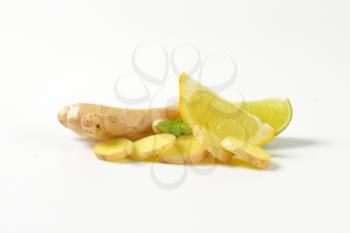 fresh ginger with lemon and lime on white background