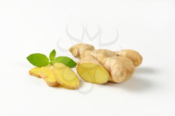 fresh ginger root on off-white background with shadows