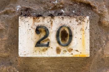House number 20 on a weathered wall