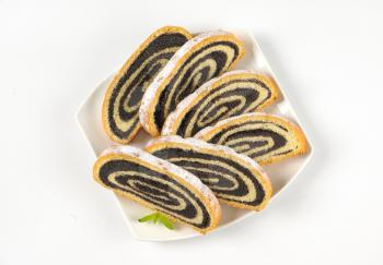 slices of poppy seed roll on white plate