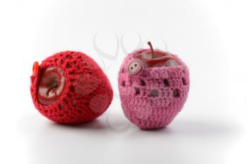 two red apples in crochet cozies