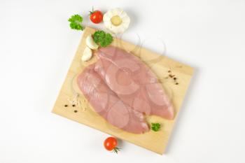 raw turkey breasts with vegetables, spice and herbs