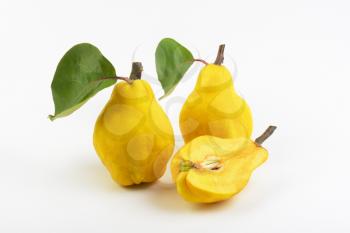 two and half yellow pears on white background