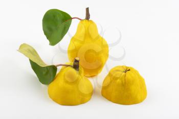 yellow pears on white background - one whole and two halves
