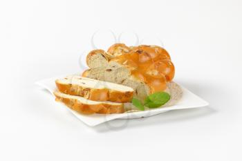 sliced Christmas sweet braided bread on white plate