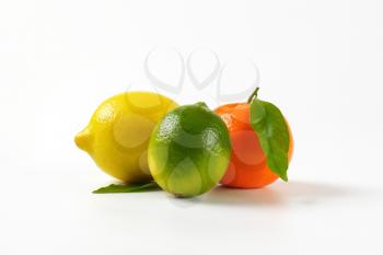 lemon, lime and tangerine on white background