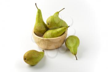 fresh green pears in wooden bowl