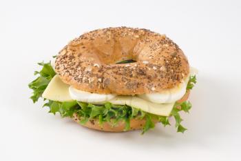 bagel sandwich with eggs and cheese on white background