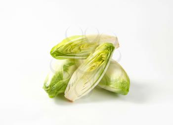 fresh Belgian endive halves on white background