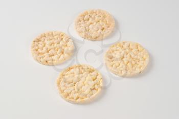 slices of puffed rice bread on white background
