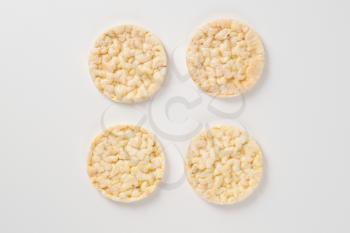 slices of puffed rice bread on white background