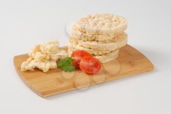 slices of puffed rice bread on wooden cutting board