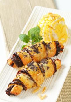 chocolate chip croissants with scoop of ice cream on white rectangular plate