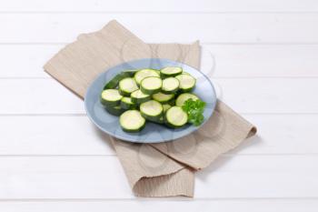plate of green zucchini slices on beige place mat