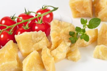 pieces of fresh parmesan cheese and cherry tomatoes - close up