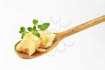 parmesan cheese and oregano on wooden spoon