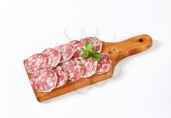 Sliced French dry sausage (Saucisson Sec)  on cutting board