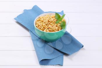 bowl of honey cereal rings on blue place mat