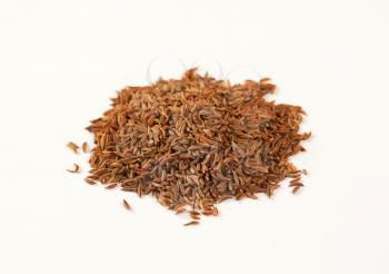 pile of caraway seeds on white background