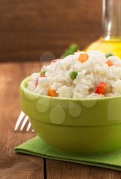bowl full of rice isolated on wooden background