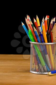 holder basket and school supplies isolated on black background