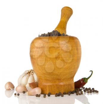 garlic, onion and pepper in mortar and pestle isolated on white background