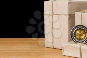 parcel wrapped and compass isolated on black  background
