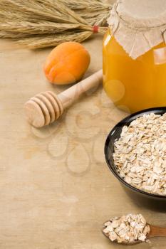 cereals oat flake and healthy food in plate on wood background