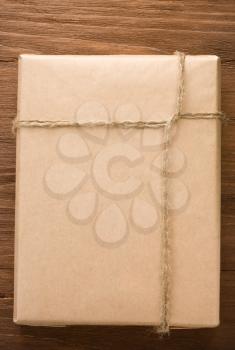 parcel wrapped packaged box on wood background