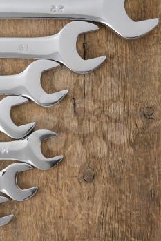wrench tool on wood background