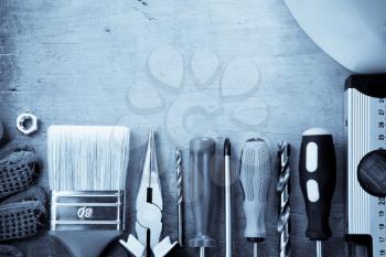 set of construction tools and instruments on wood background