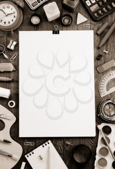 school supplies and paper on wooden background