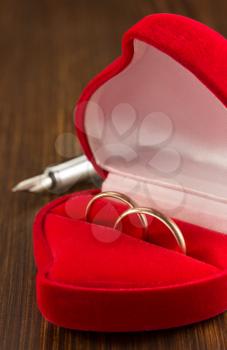 wedding ring on wooden background